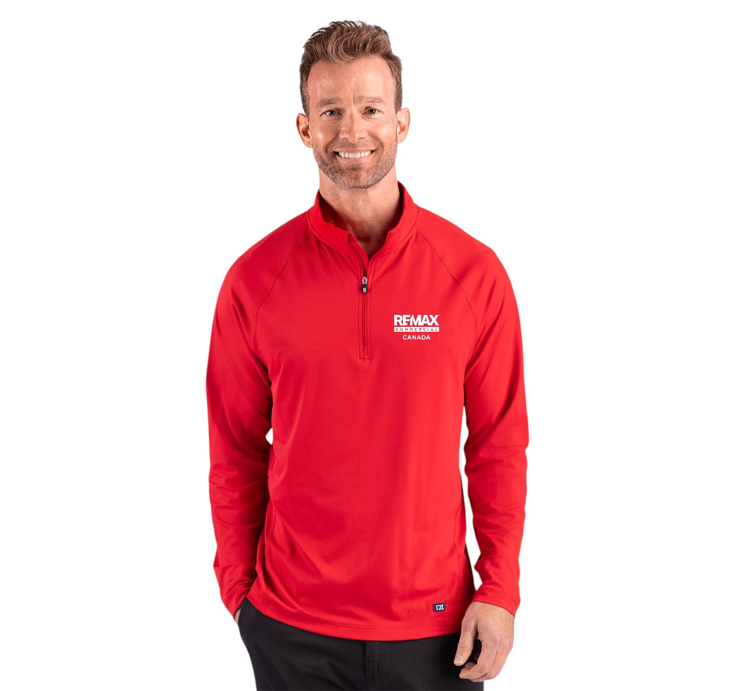 A man wearing a red long-sleeve quarter-zip pullover with a white 'REMAX' logo on the left chest, photographed against a solid white background.