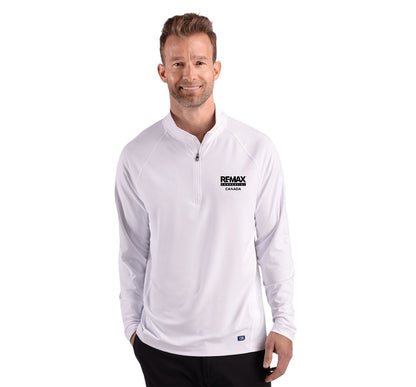 A man wearing a white long-sleeve quarter-zip pullover with a black 'REMAX' logo on the left chest, paired with black pants, against a plain white background.