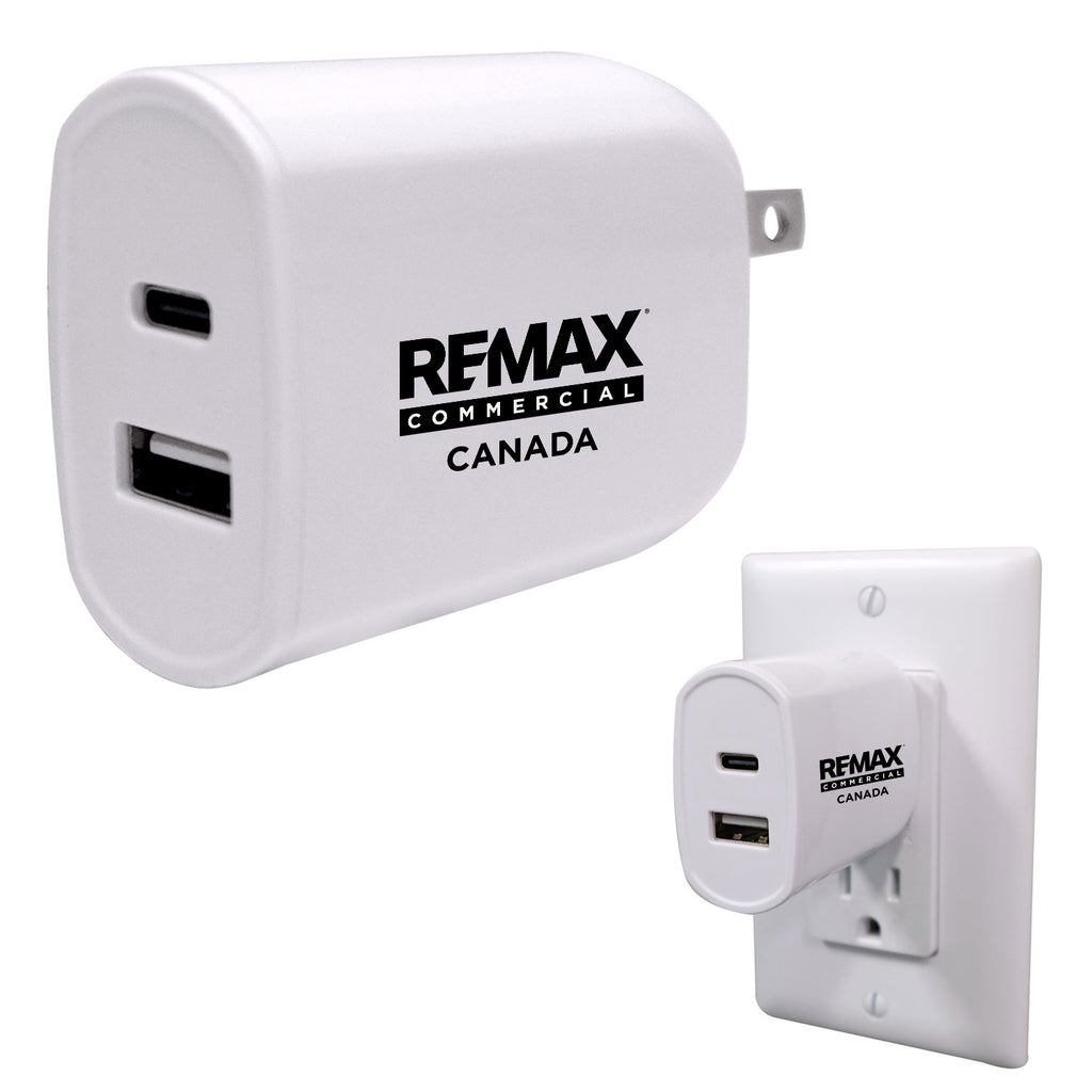 White RFMAX Commercial Canada USB-A wall charger shown from the front and plugged into a white wall outlet, on a light gray background.
