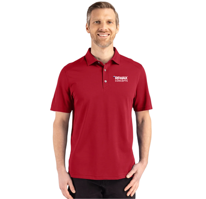 A man wearing a red short-sleeve polo shirt with a white 'REMAX CONCEPTS' logo on the left chest, photographed against a plain white background.